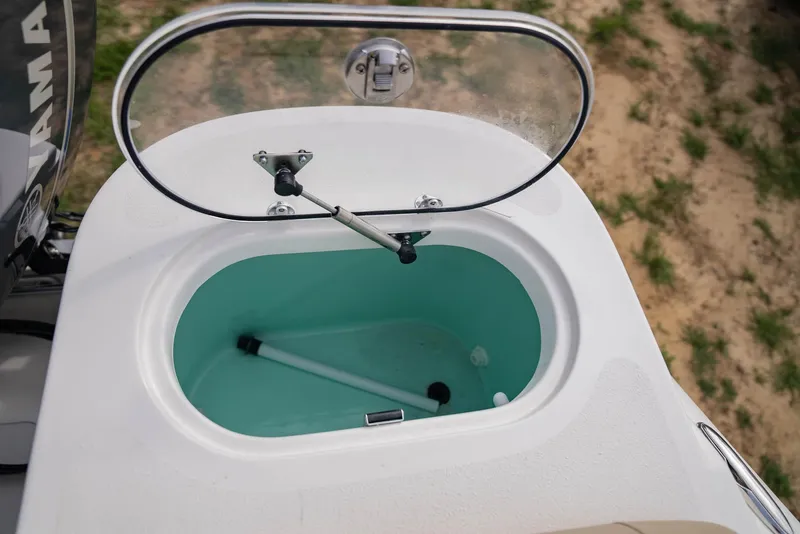 Slide: The Image of NauticStar 2102 Legacy 2022 livewell with open lid, showcasing interior design. - 10