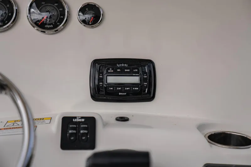 Slide: The Image of NauticStar 2102 Legacy 2022 dashboard with gauges and Infinity stereo system. - 18