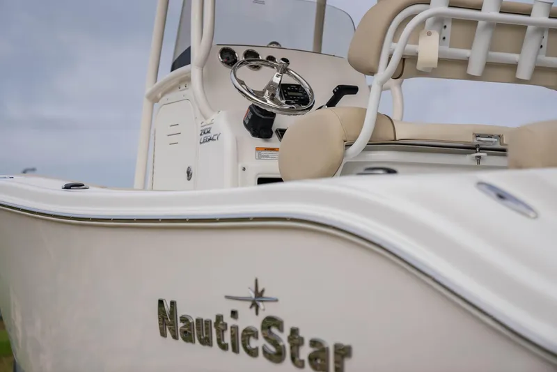 Slide: The Image of 2022 NauticStar 2102 Legacy boat, close-up of helm and seating area. - 19