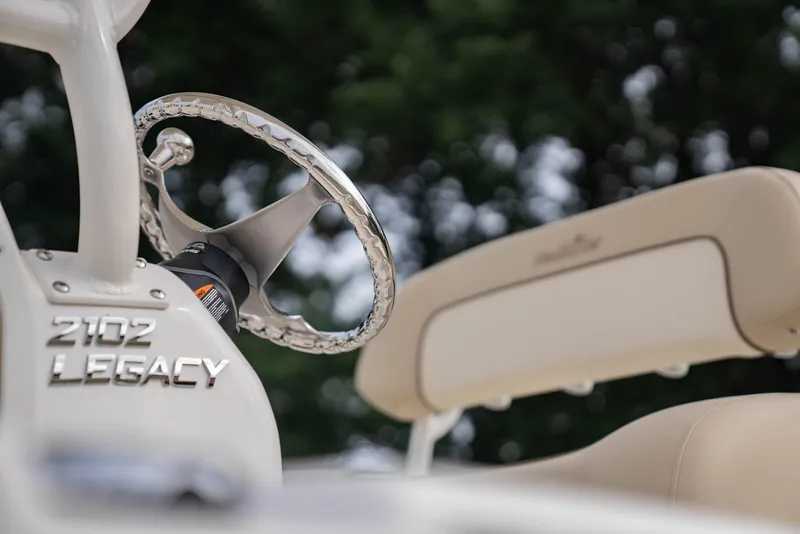 Slide: The Image of Close-up of 2022 NauticStar 2102 Legacy boat steering wheel and seat. - 23