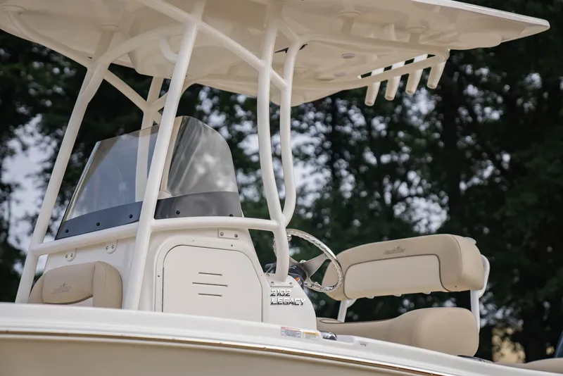 Slide: The Image of 2022 NauticStar 2102 Legacy boat helm with seating and canopy. - 25