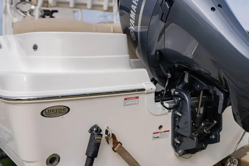 Slide: The Image of 2022 NauticStar 2102 Legacy boat with Yamaha outboard motor, rear view. - 4