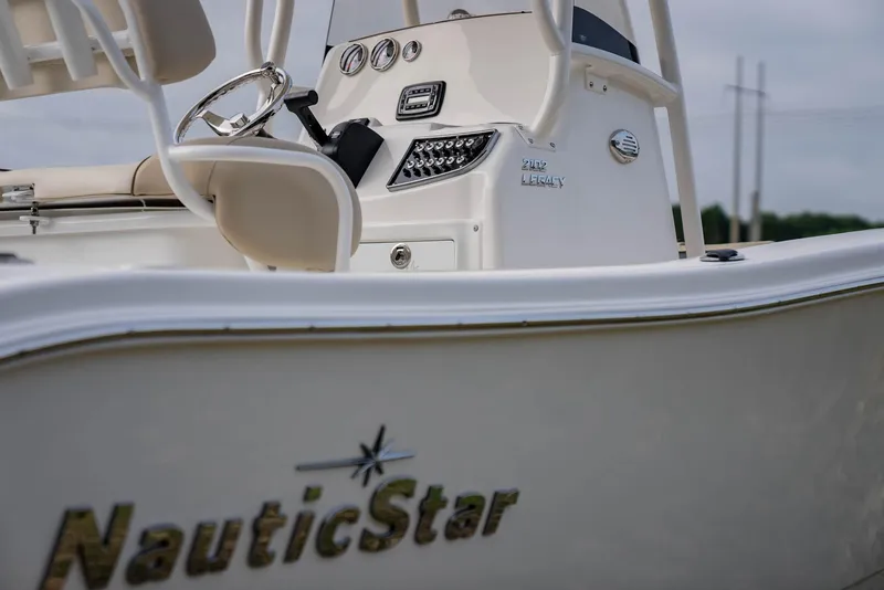 Slide: The Image of 2022 NauticStar 2102 Legacy boat, close-up of helm and branding. - 5