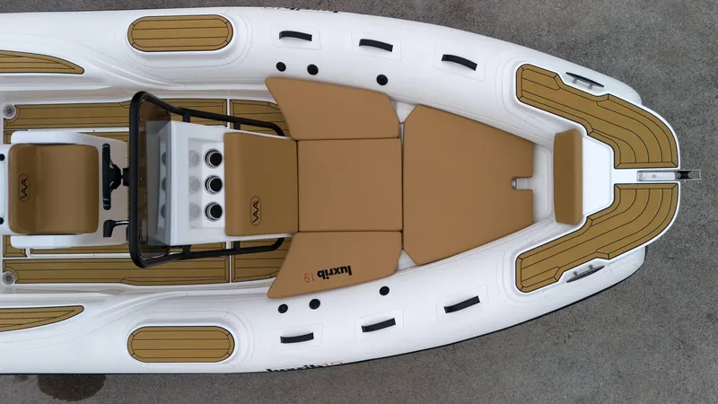 Slide: The Image of Aerial view of 2025 Aqvaboats Luxrib 19 luxury inflatable boat with tan seating. - 9