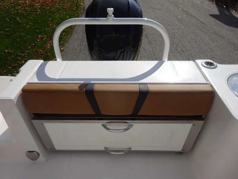 Slide: The Image of 2024 Robalo R230 boat seating and storage area with outboard motor. - 11