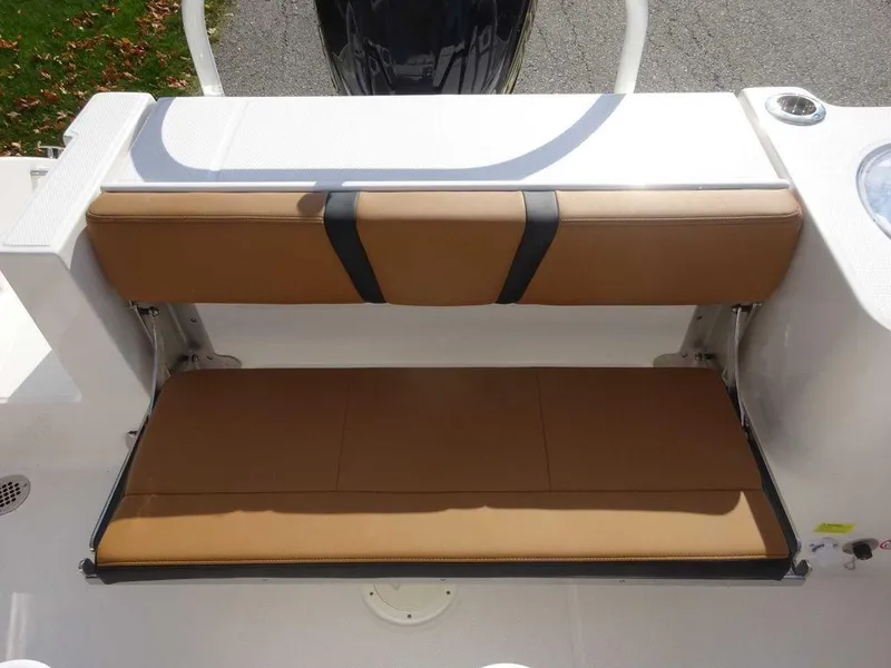 Slide: The Image of 2024 Robalo R230 boat with tan cushioned seating and white deck. - 12