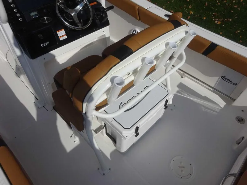 Slide: The Image of 2024 Robalo R230 boat interior with tan seating and rod holders. - 2