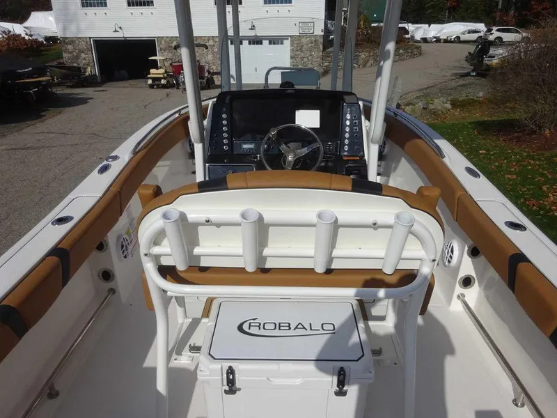Slide: The Image of 2024 Robalo R230 boat interior with helm, seating, and rod holders. - 3
