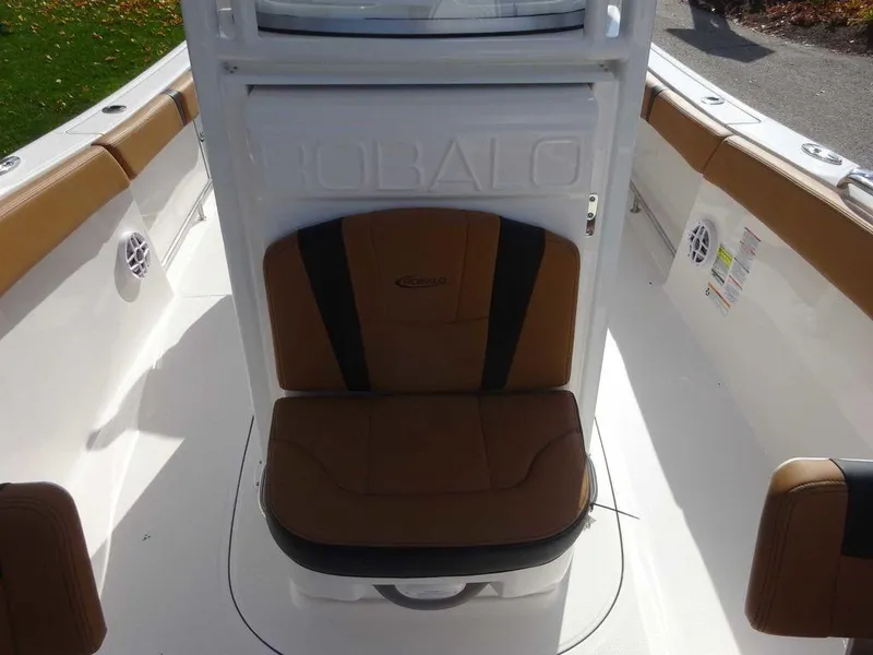 Slide: The Image of 2024 Robalo R230 boat interior with brown seating and white console. - 5