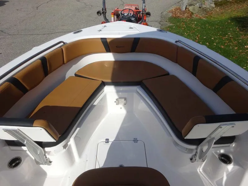 Slide: The Image of 2024 Robalo R230 boat interior with brown cushioned seating. - 8