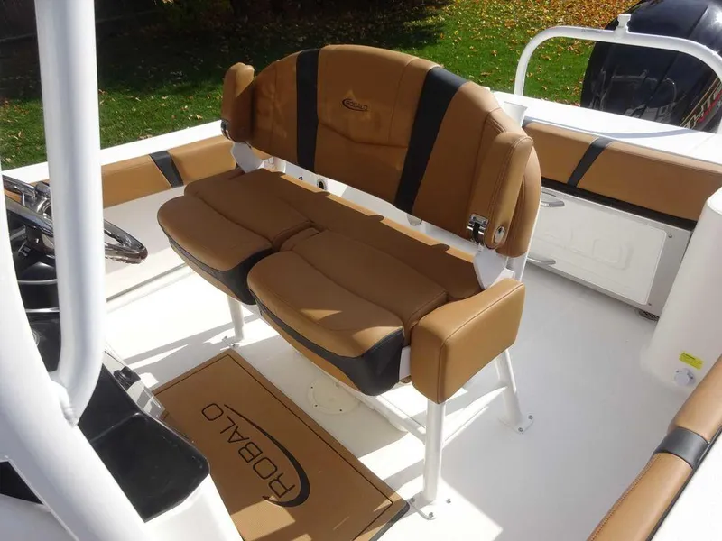 Slide: The Image of 2024 Robalo R230 boat interior with tan and black seating. - 9