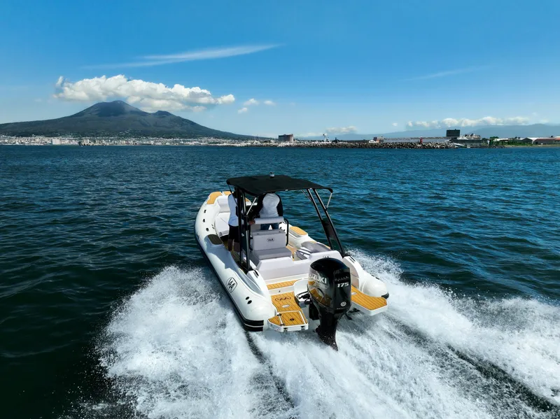 Slide: The Image of Aqvaboats Luxrib 22 (2025) cruising on open water with scenic mountain backdrop. - 1
