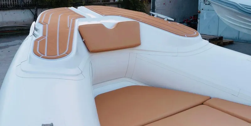 Slide: The Image of Aqvaboats Luxrib 22, 2025 model, featuring tan leather seating and sleek white design. - 14