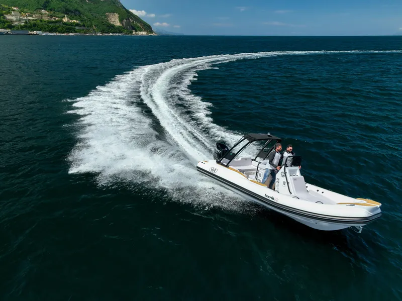 Slide: The Image of Aqvaboats Luxrib 22 (2025) cruising on open water, leaving a wake trail. - 2