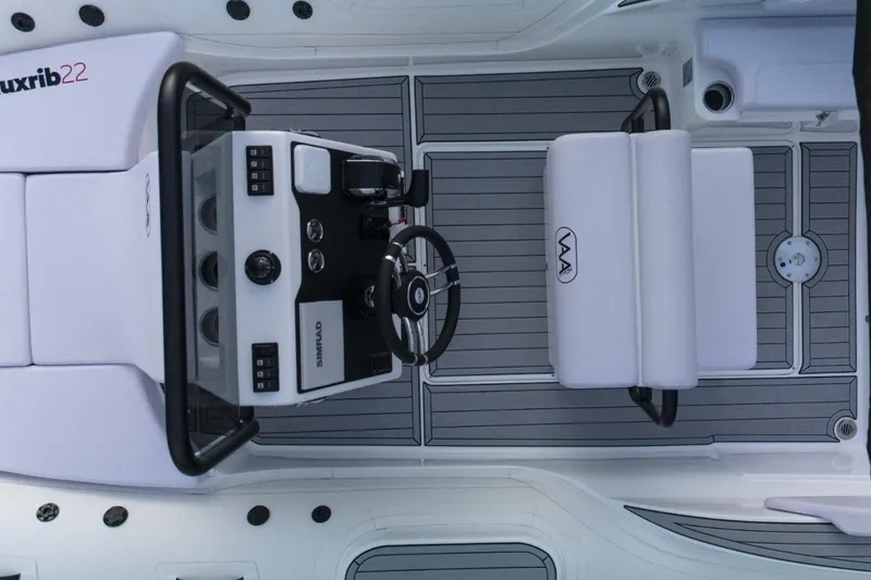 Slide: The Image of 2025 Aqvaboats Luxrib 22 boat interior with steering console and seating. - 21