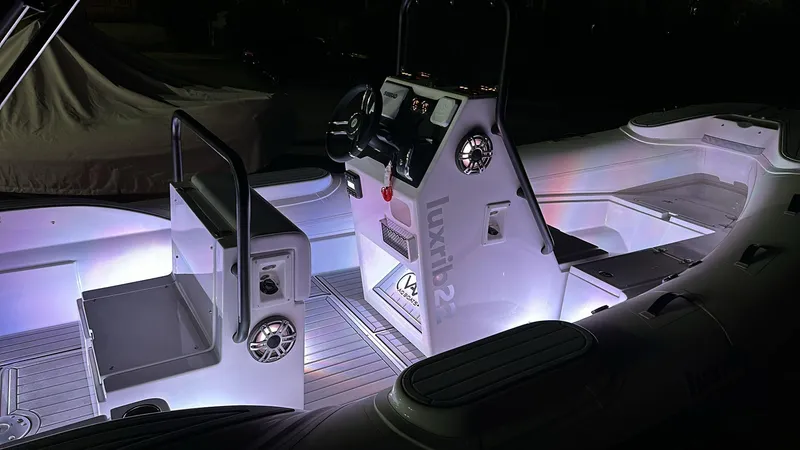 Slide: The Image of Interior of 2025 Aqvaboats Luxrib 22 illuminated at night. - 25