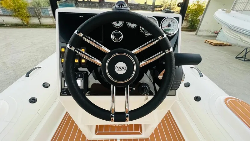 Slide: The Image of Steering wheel of 2025 Aqvaboats Luxrib 22, featuring modern dashboard controls. - 6