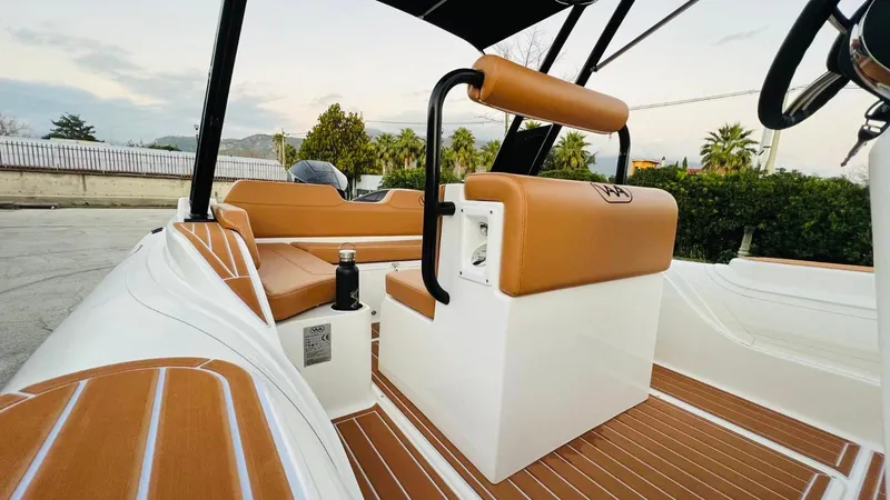 Slide: The Image of 2025 Aqvaboats Luxrib 22 interior with tan seating and sleek design. - 7