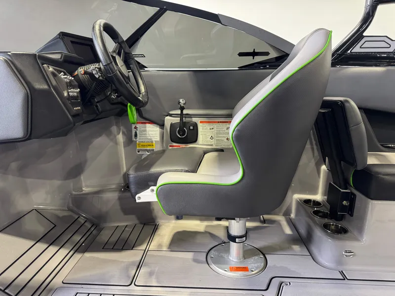 Slide: The Image of Interior of a 2021 Moomba Max boat with steering wheel and seat. - 23