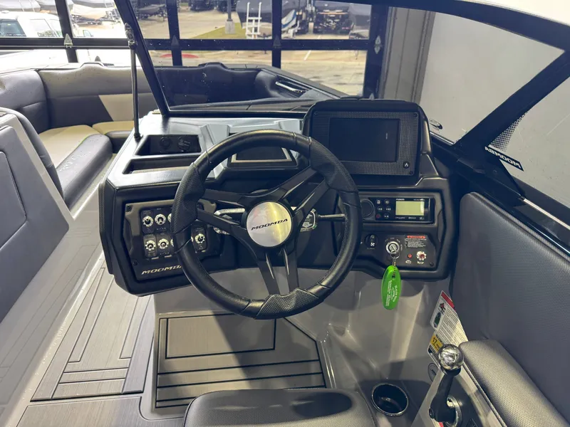 Slide: The Image of Interior of a 2021 Moomba Max boat with steering console. - 26
