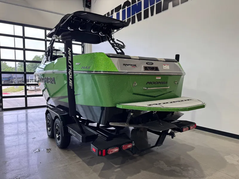 Slide: The Image of Green 2021 Moomba Max boat in a garage. - 5