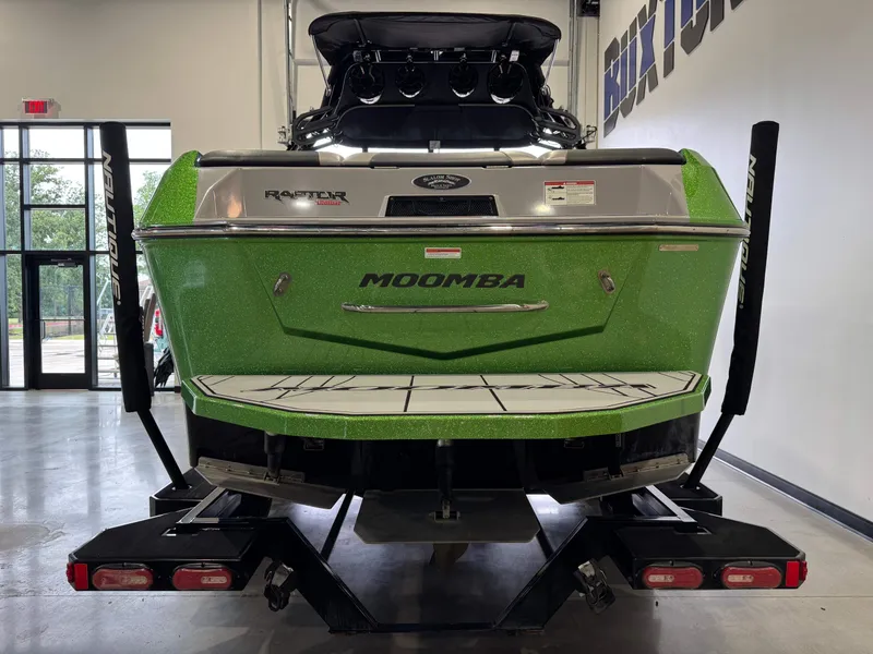 Slide: The Image of Green 2021 Moomba Max boat on trailer in a showroom. - 6