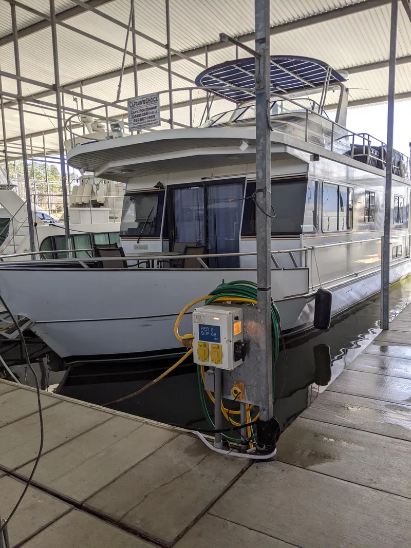 The Image of 2001 Monticello River Yacht docked in a covered marina. - 0