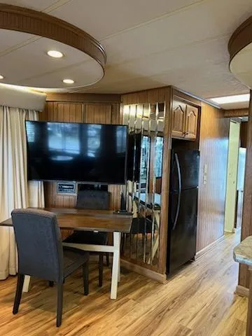 Slide: The Image of Interior of 2001 Monticello River Yacht with modern amenities and wood paneling. - 11