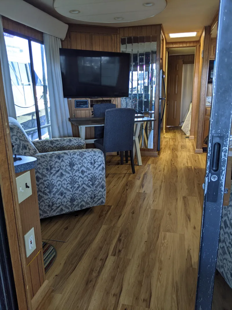 Slide: The Image of Interior of a 2001 Monticello River Yacht with wooden flooring and modern furnishings. - 12