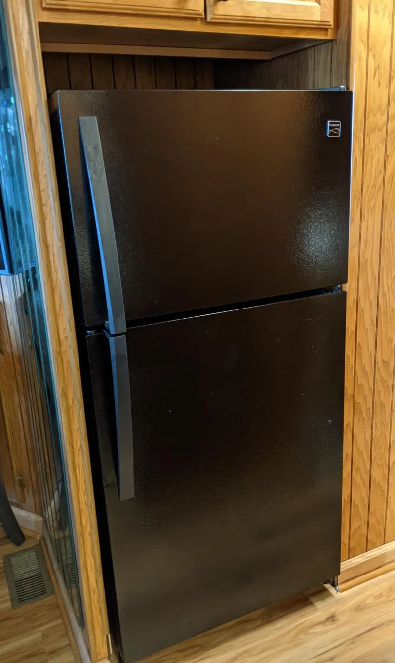 Slide: The Image of Black refrigerator in a 2001 Monticello River Yacht kitchen. - 18