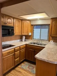 Slide: The Image of 2001 Monticello River Yacht kitchen with wooden cabinets and modern appliances. - 19