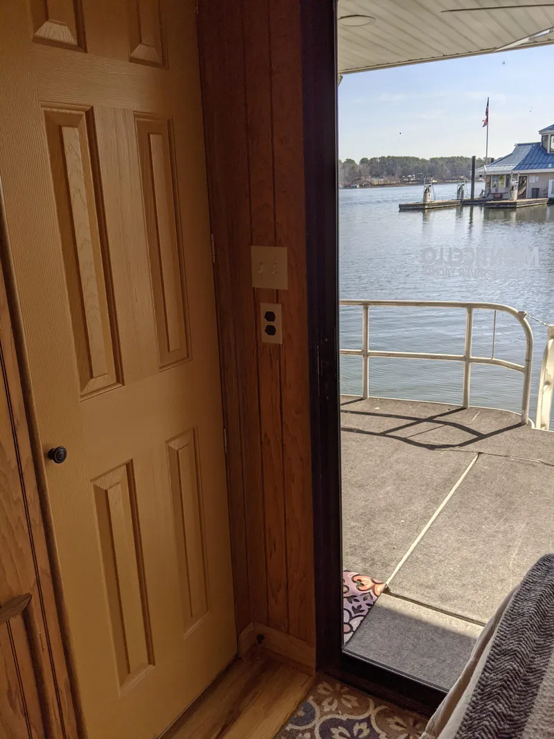 Slide: The Image of Interior view of 2001 Monticello River Yacht with door and water view. - 26