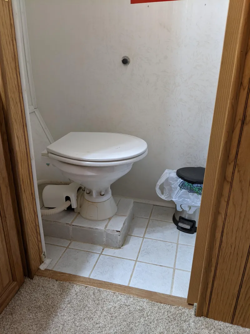 Slide: The Image of 2001 Monticello River Yacht bathroom with white toilet and tiled floor. - 29