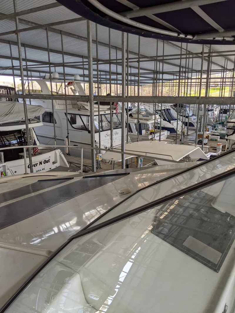 Slide: The Image of 2001 Monticello River Yacht docked in a marina with other boats. - 3