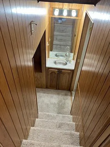 Slide: The Image of Staircase leading to a wooden interior with a sink on a 2001 Monticello River Yacht. - 30