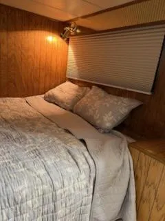 Slide: The Image of Cozy bedroom in 2001 Monticello River Yacht with wood paneling and soft bedding. - 32