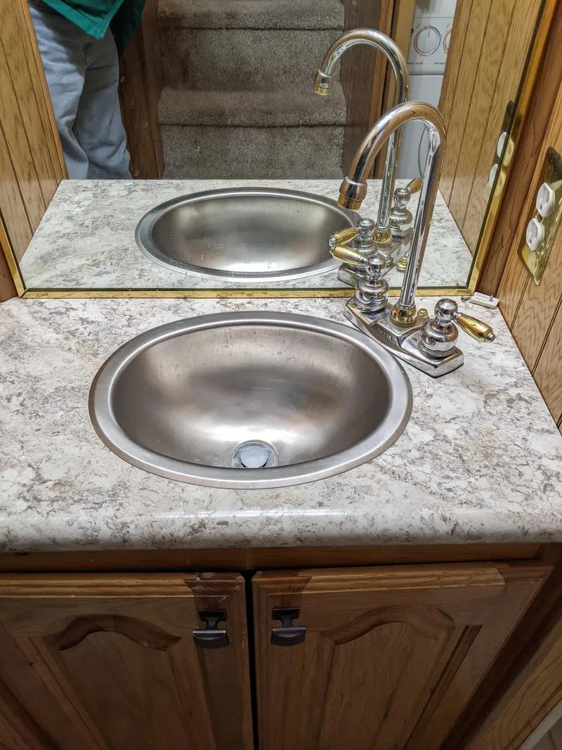 Slide: The Image of 2001 Monticello River Yacht bathroom sink with marble countertop and mirrored backsplash. - 33