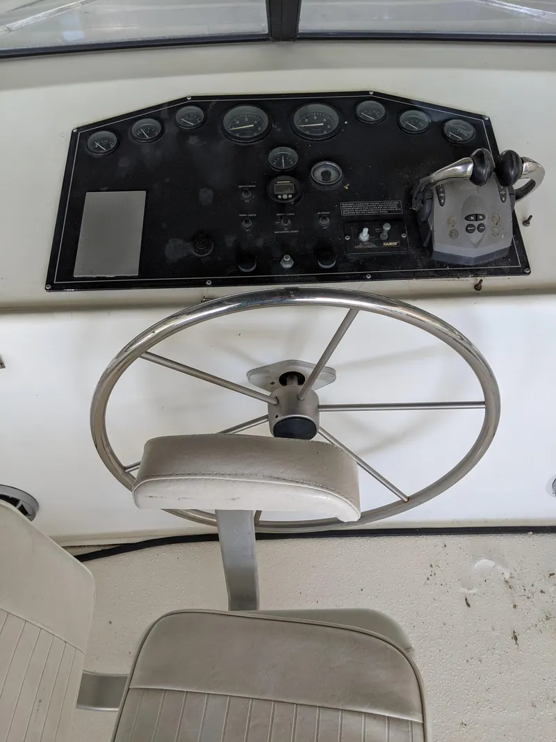 Slide: The Image of 2001 Monticello River Yacht helm with steering wheel and control panel. - 37