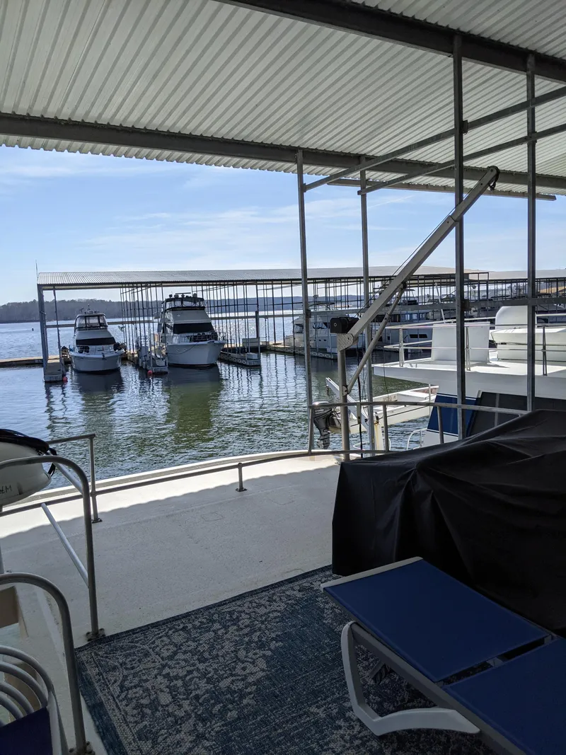 Slide: The Image of 2001 Monticello River Yacht docked at a marina with other boats. - 38