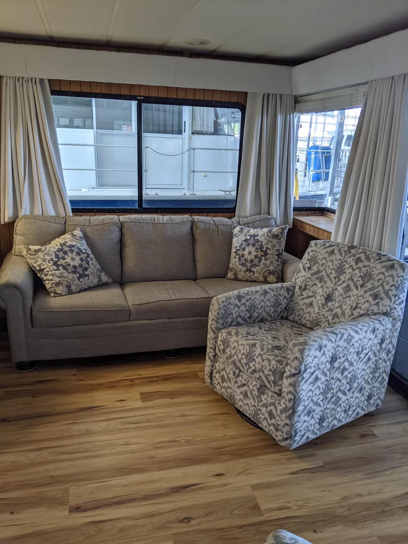 Slide: The Image of Living area of a 2001 Monticello River Yacht with sofa and armchair. - 4