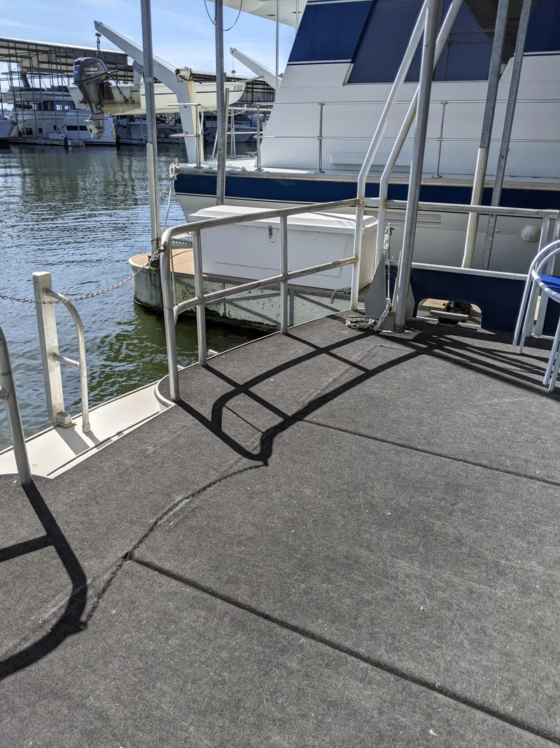 Slide: The Image of 2001 Monticello River Yacht docked at a marina with a view of the water. - 43