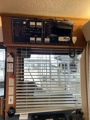 Slide: The Image of Control panel inside a 2001 Monticello River Yacht, featuring blinds and safety equipment. - 45