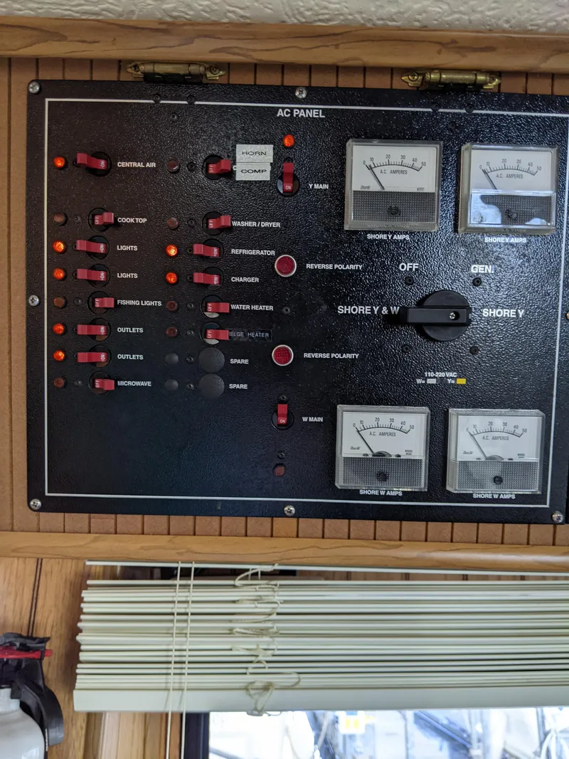 Slide: The Image of 2001 Monticello River Yacht AC panel with switches and gauges. - 47