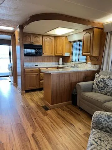 Slide: The Image of Interior of 2001 Monticello River Yacht with wooden kitchen and cozy seating area. - 8