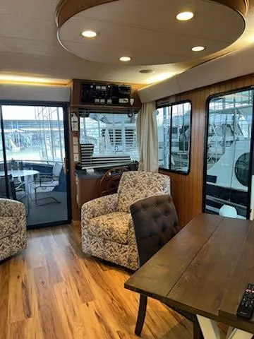 Slide: The Image of Interior of a 2001 Monticello River Yacht with wood flooring and plush seating. - 9