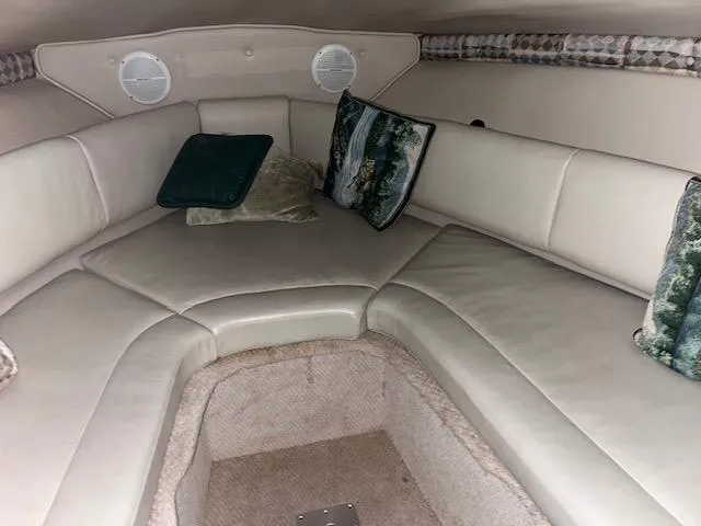 Slide: The Image of Interior cabin of a 2000 Chaparral 240 Signature boat with cushioned seating. - 10