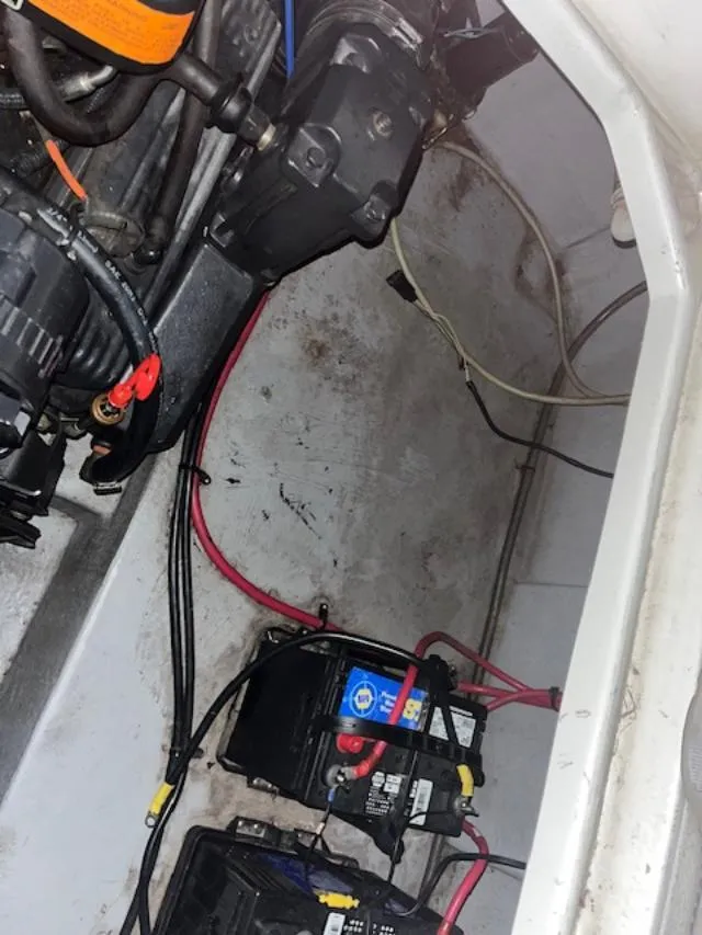 Slide: The Image of Engine compartment of a 2000 Chaparral 240 SIGNATURE boat with visible batteries and wiring. - 14