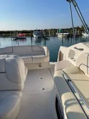 Slide: The Image of 2000 Chaparral 240 SIGNATURE boat interior with docked boats in the background. - 5