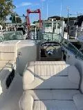 Slide: The Image of 2000 Chaparral 240 SIGNATURE boat interior with white seating and steering wheel. - 6