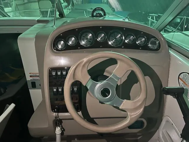 Slide: The Image of 2000 Chaparral 240 SIGNATURE boat dashboard with steering wheel and instrument panel. - 7
